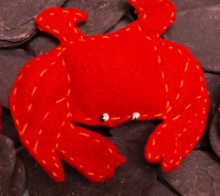 Woman standing behind a display of beaded headdresses