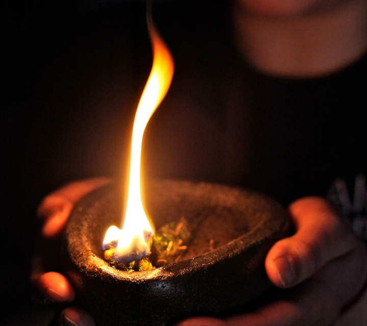 Woman standing behind a display of beaded headdresses
