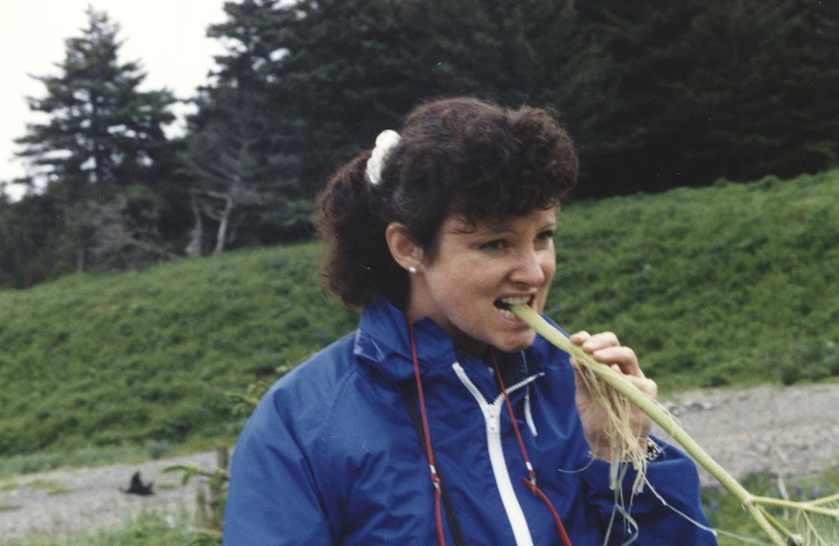 Woman chewing cow parsnip