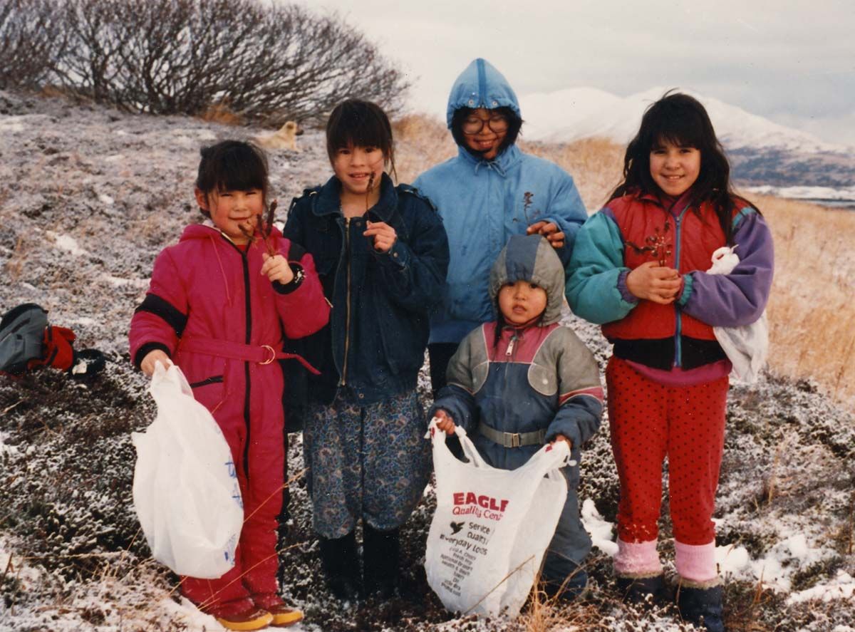 People gathering labrador tea